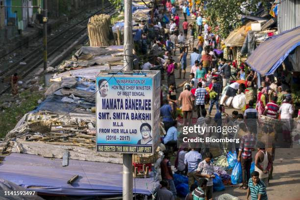 Lamp post with a lightbox featuring West Bengal Chief Minister Mamata Banerjee stands at Mallick Ghat flower market in Kolkata, West Bengal, India,...