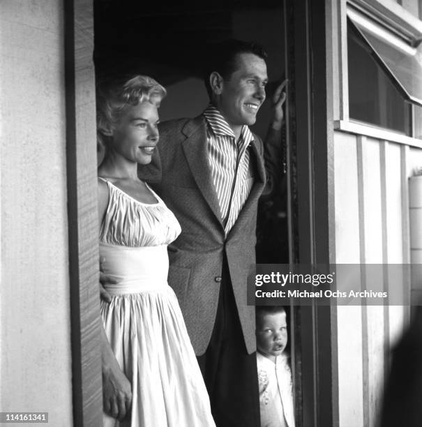 Joan and Johnny Carson host of The Johnny Carson Show on CBS, at home with one of their three sons on July 5, 1956 in Los Angeles, California.