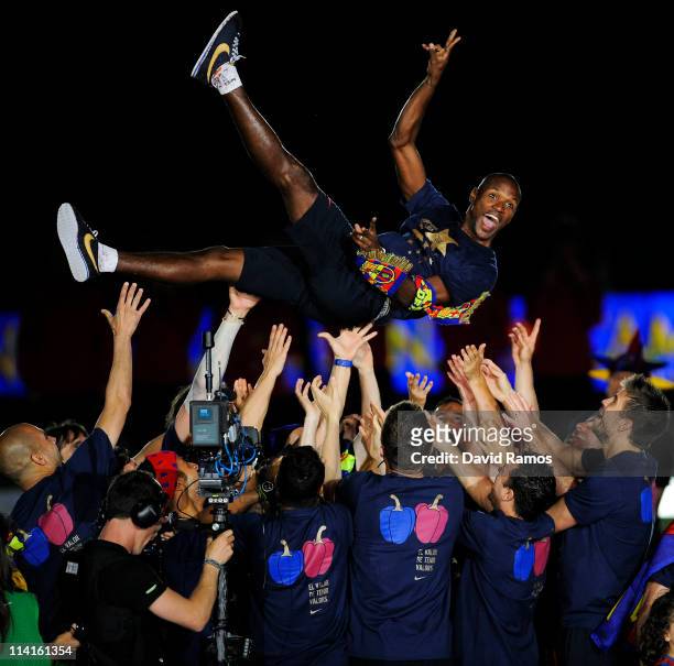 Eric Abidal of FC Barcelona is lifted by his team-mates during the celebrations for winning the Spanish Liga at the Camp Nou Stadium on May 13, 2011...