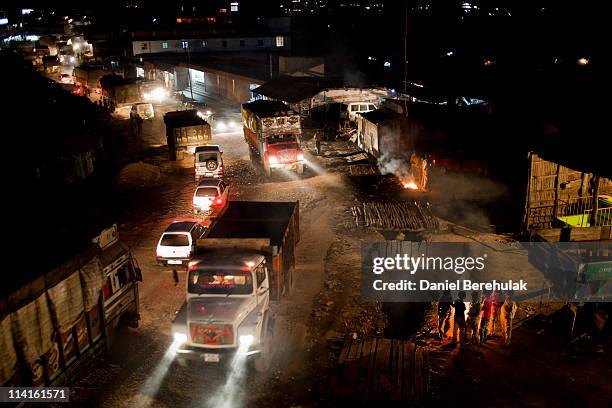 Coal trucks and other vehicles move through town after being delayed due to a traffic accident on April 15, 2011 in Lad Rymbai, in the district of...