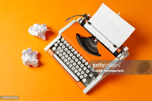 orange 70s typewriter with blank page - love letter stock pictures, royalty-free photos & images