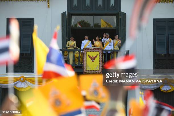 Thailand's Princess Sirivannavari Nariratana uses her phone as she stands with her brother Prince Dipangkorn Rasmijoti , sister Princess...