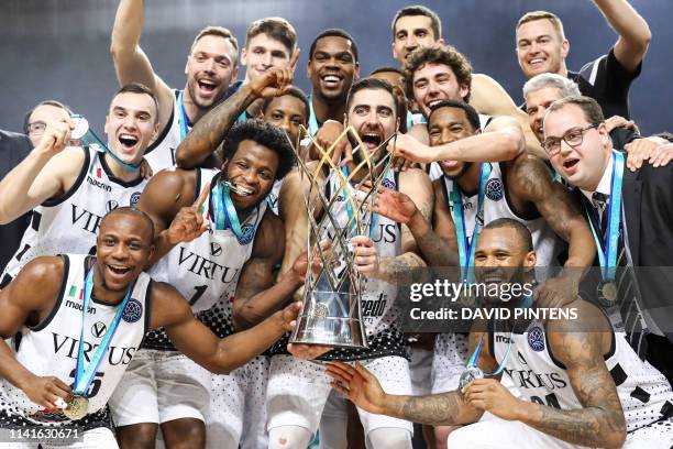 Bologna's players celebrate with the trophy after winning a basketball match between Spanish team CB 1939 Canarias Tenerife and Italian Virtus...