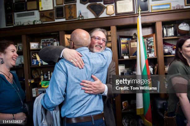 Former pages Herb Krohn, right, of Seattle, and David Fram, of New York City, hug upon arriving in the Longworth Building office of Rep. Joe Wilson,...