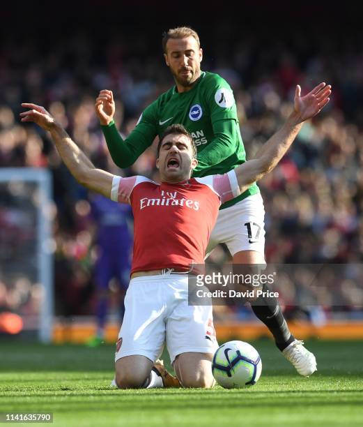 Sokratis of Arsenal is challenged by Glenn Murray of Brigthon during the Premier League match between Arsenal FC and Brighton & Hove Albion at...