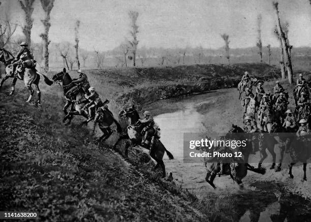 British cavalry charge across a river during World War One.
