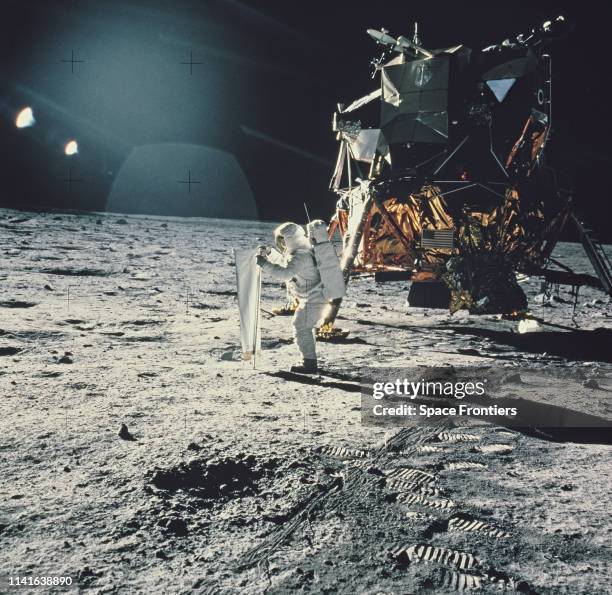 Lunar Module Pilot Edwin 'Buzz' Aldrin sets up the Solar Wind Composition experiment, part of the Early Apollo Scientific Experiments Package , at...