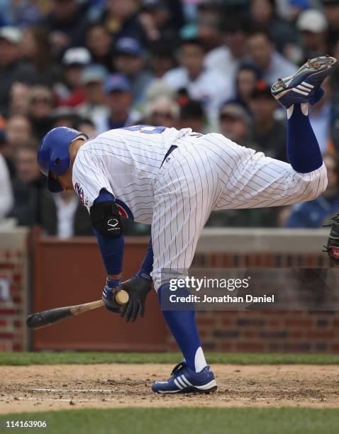 Reed Johnson of the Chicago Cubs hops out of the way of an inside pitch against the San Francisco Giants at Wrigley Field on May 13, 2011 in Chicago,...