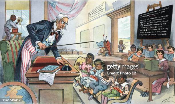 School begins by Louis Dalrymple, 1866-1905, 1899 chromolithograph. Print shows Uncle Sam as a teacher, standing behind a desk in front of his new...