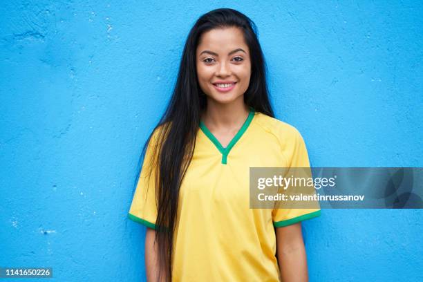 female soccer fan on blue background - soccer uniform stock pictures, royalty-free photos & images