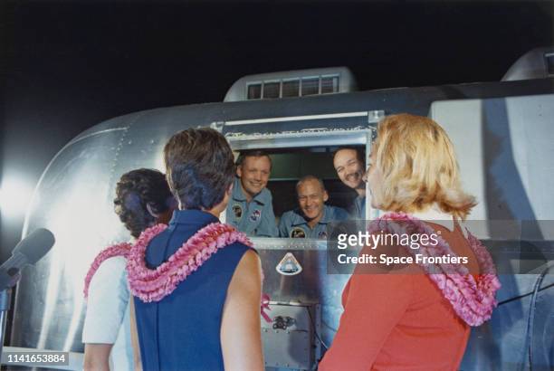 The three crew members of NASA's Apollo 11 lunar landing mission are greeted by their wives after their arrival at Ellington Air Force Base near...