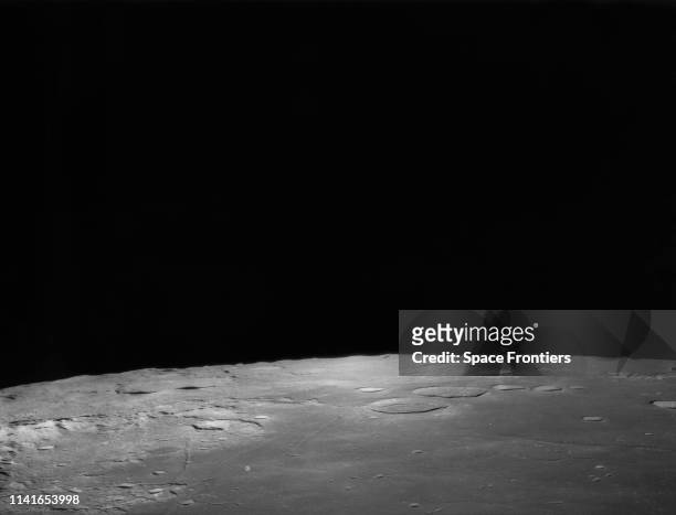 Part of Moon's horizon as seen from lunar orbit during NASA's historic lunar landing mission, July 1969. Tranquillity Base is in the foreground, and...