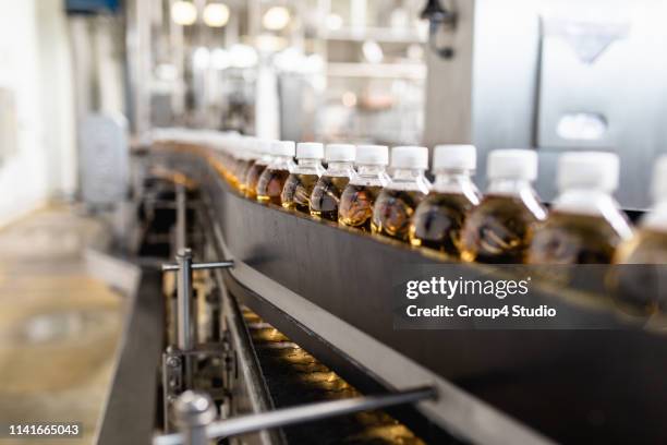production line for juice bottling - bottling plant stock pictures, royalty-free photos & images