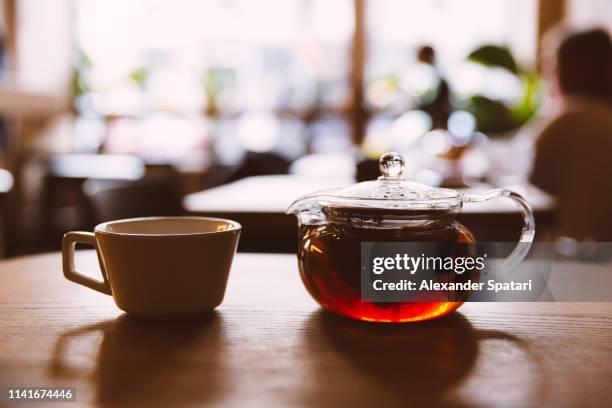 close up of glass teapot and tea cup on the table in a cafe - tea room fotografías e imágenes de stock