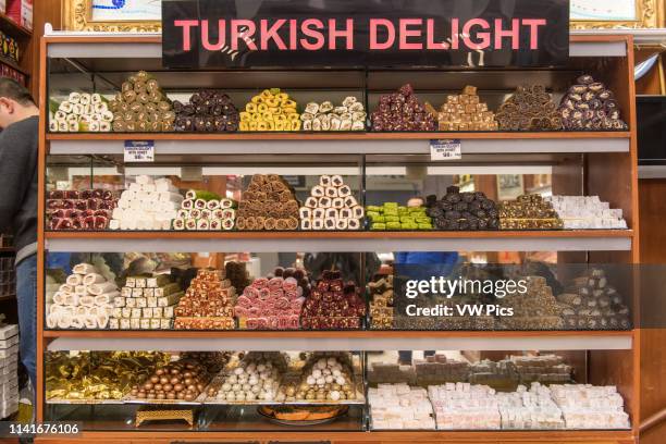 Glass case in front of shop holds an assortment of tempting Turkish delights for sale at Istanbul Spice bazaar in Turkey.