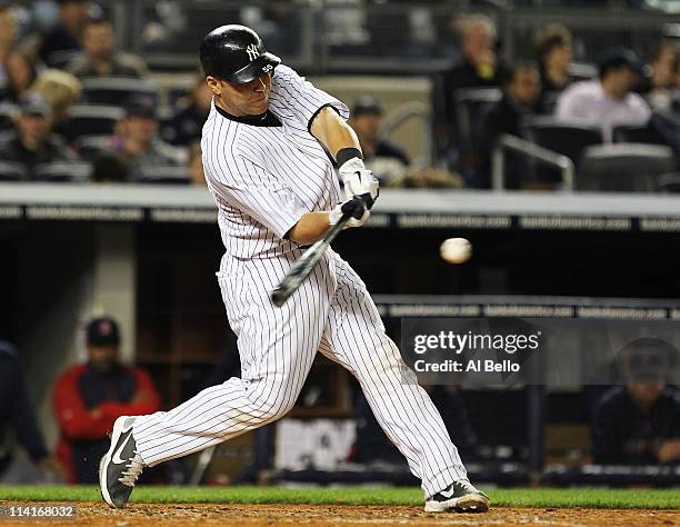 Russell Martin of the New York Yankees hits a two run home run against the Boston Red sox during their game on May 13, 2011 at Yankee Stadium in the...