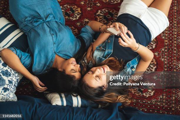 happy friends lying on the hug and taking a selfie - area rug stock pictures, royalty-free photos & images