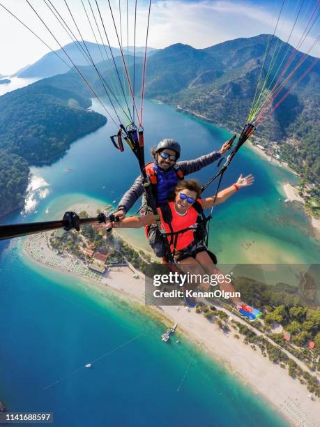 tandem springen im gleitschirmfliegen. - abenteuer stock-fotos und bilder