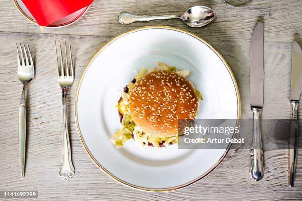 fast food deluxe with hamburger and french fries served with silver cutlery. - burger top view stock pictures, royalty-free photos & images