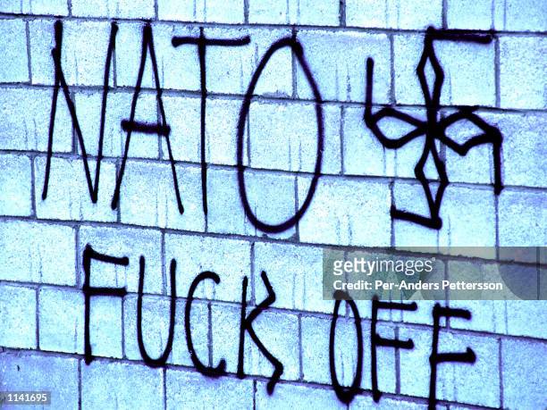 Anti-NATO graffiti is written on a house June 24, 1999 outside Djakovica, Kosovo. Most serbs fled Kosovo into Serbia when NATO entered Kosovo in June...
