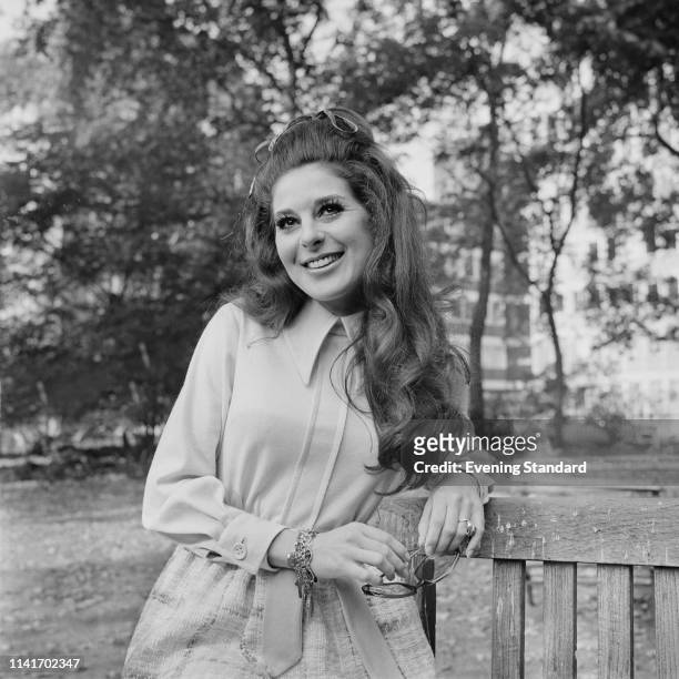 American singer-songwriter Bobbie Gentry sitting on a bench in a public park, UK, 13th October 1969.