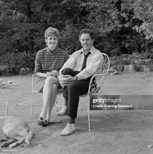 Scottish actress Elspet Gray and English actor and activist Brian Rix sitting in a back garden, UK, 15th October 1969.