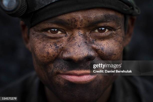 Coal miner poses for a portrait outside of a coal mine on April 13, 2011 near the village of Latyrke near Lad Rymbai, in the district of Jaintia...