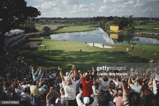 Severiano Ballesteros of Spain with arms aloft celebrates on the 18th green with the crowd after Europe tied the 28th Ryder Cup Matches 14 to14...