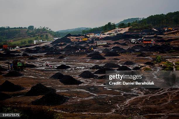 Workers load coal onto trucks at a coal depot on April 16, 2011 near to Lad Rymbai, in the district of Jaintia Hills, India. The Jaintia hills,...