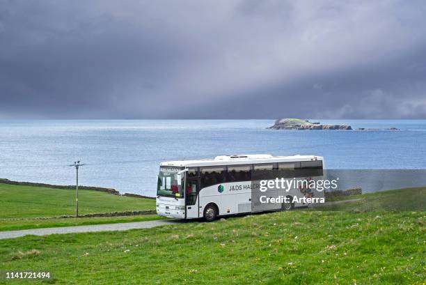 Halcrow bus driving tourists to Sumburgh Head at the southern tip of Mainland of Shetland, Scotland, UK.