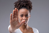 Attractive young African woman giving halt gesture
