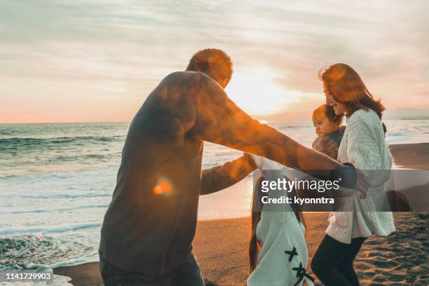 enjoy sunset beach - japanese couple beach stock pictures, royalty-free photos & images
