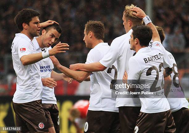 Matthias Lehmann of St. Pauli celebrates with his team mates after scoring his team's first goal during the Bundesliga match between FSV Mainz 05 and...