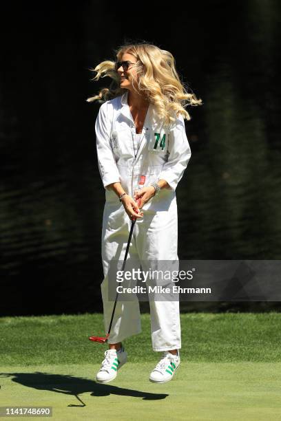 Kelley Cahill, fiancee of Jon Rahm of Spain ,, celebrates after making a putt during the Par 3 Contest prior to the Masters at Augusta National Golf...