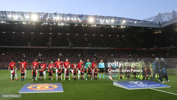 The two teams line up ahead of the UEFA Champions League Quarter Final first leg match between Manchester United and FC Barcelona at Old Trafford on...