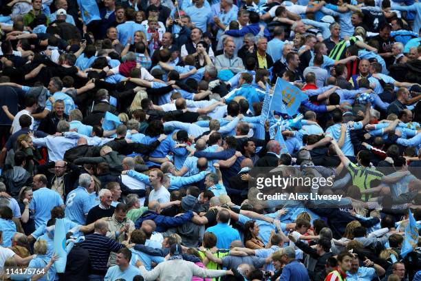 Manchester City fans celebrate the opening goal by doing the 'Poznan' during the FA Cup sponsored by E.ON Final match between Manchester City and...