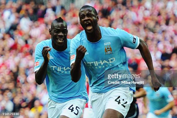 Yaya Toure of Manchester City celebrates with Mario Balotelli after scoring during the FA Cup sponsored by E.ON Final match between Manchester City...
