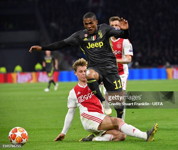 Douglas Costaof Juventus is challenged by Frenkie De Jong of Ajax during the UEFA Champions League Quarter Final first leg match between Ajax and...