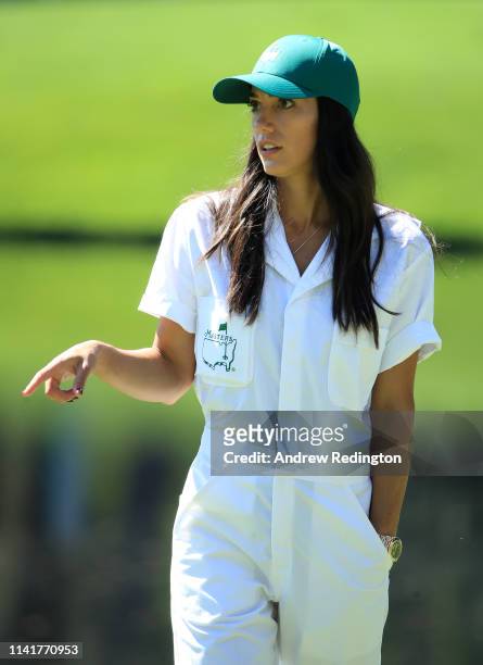 Allison Stokke, fiancee of Rickie Fowler of the United States ,, looks on during the Par 3 Contest prior to the Masters at Augusta National Golf Club...