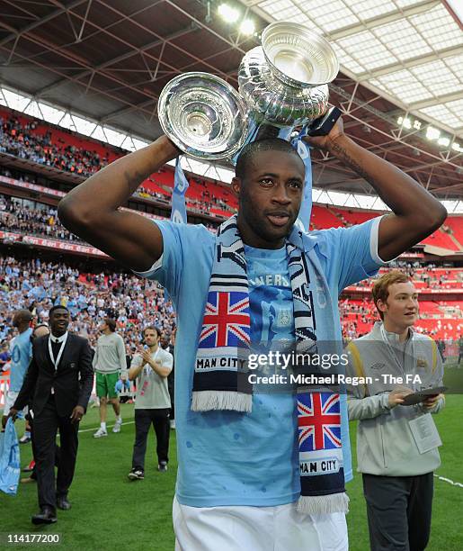 Goal scorer Yaya Toure of Man City celebrates with the cup after the The FA Cup sponsored by E.0N 2011 Final match between Manchester City and Stoke...