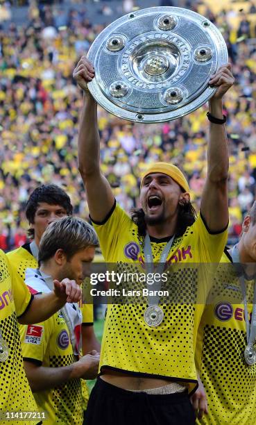 Neven Subotic of Dortmund lifts the trophy after the Bundesliga match between Borussia Dortmund and Eintracht Frankfurt at Signal Iduna Park on May...