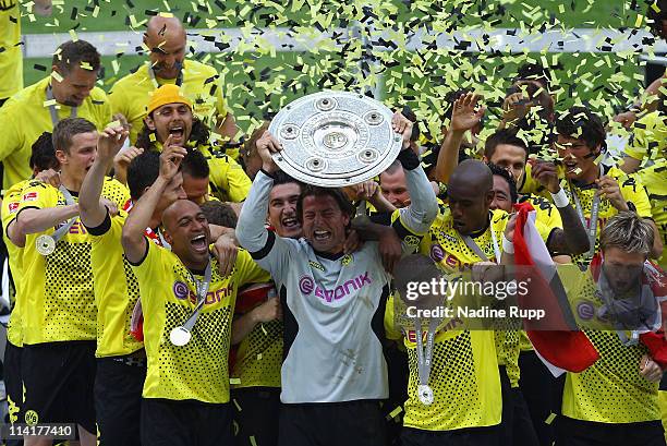 Goalkeeper and captain Roman Weidenfeller of Dortmund rises the trophy and celebrates with team mates winning the German Championship after the...