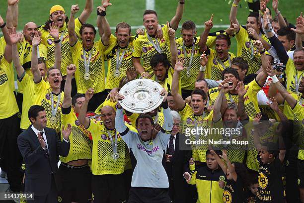 Goalkeeper and captain Roman Weidenfeller of Dortmund rises the trophy and celebrates with team mates winning the German Championship after the...