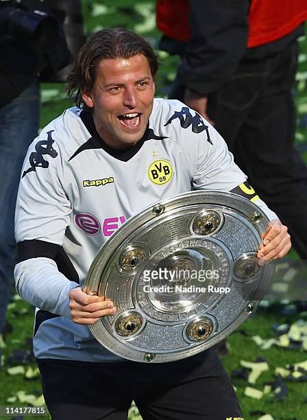 Goalkeeper and captain Roman Weidenfeller of Dortmund rises the trophy and celebrates winning the German Championship after the Bundesliga match...