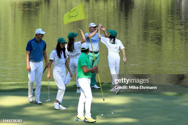 Justin Thomas of the United States celebrates with girlfriend Jillian Wisniewski during the Par 3 Contest prior to the Masters at Augusta National...