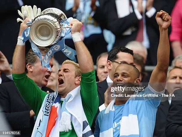 Joe Hart and Vincent Kompany of Man City celebrate with the trophy during the The FA Cup sponsored by E.0N 2011 Final match between Manchester City...