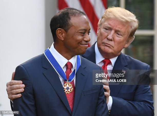 President Donald Trump presents US golfer Tiger Woods with the Presidential Medal of Freedom during a ceremony in the Rose Garden of the White House...