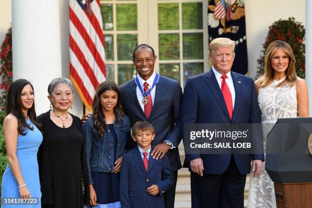 Professional golfer Tiger Woods stands with his girlfriend Erica Herman , Kultida Woods , Sam Alexis Woods , Charlie Axel Woods , US President Donald...