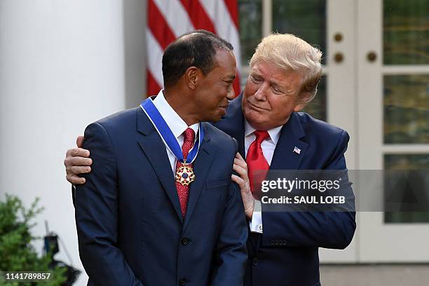 President Donald Trump presents US golfer Tiger Woods with the Presidential Medal of Freedom during a ceremony in the Rose Garden of the White House...