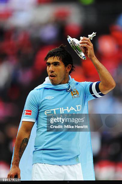 Carlos Tevez celebrates after he and his Manchester City team mates win the FA Cup sponsored by E.ON Final match between Manchester City and Stoke...